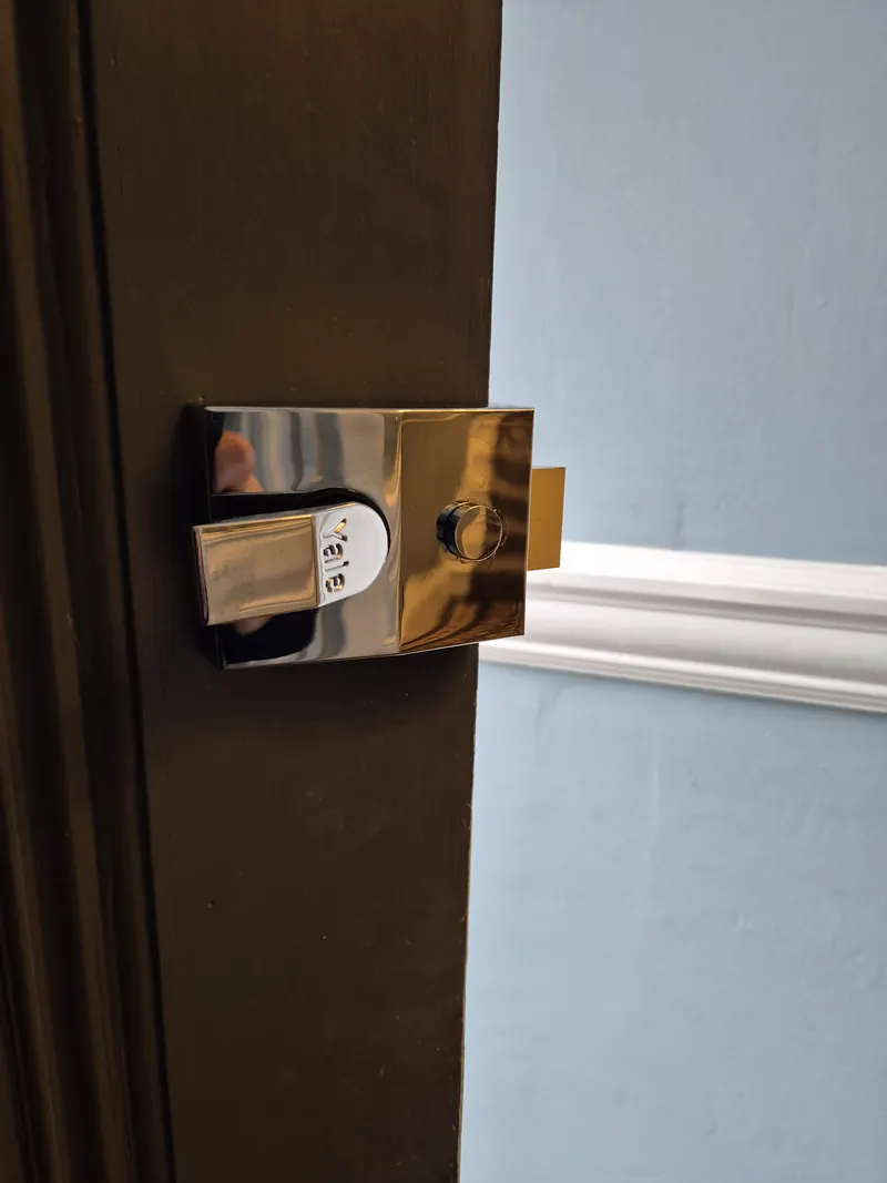 Night latch lock on a wooden door in Leeds